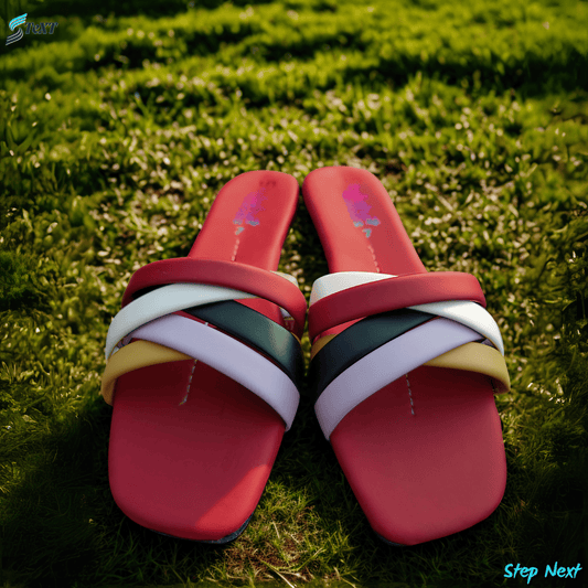 Red slipper with multicolor straps on grass